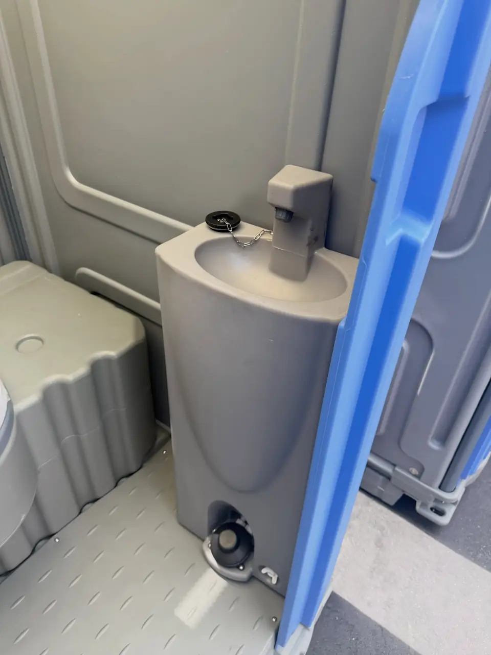 Foot-pump hand sink inside a porta potty