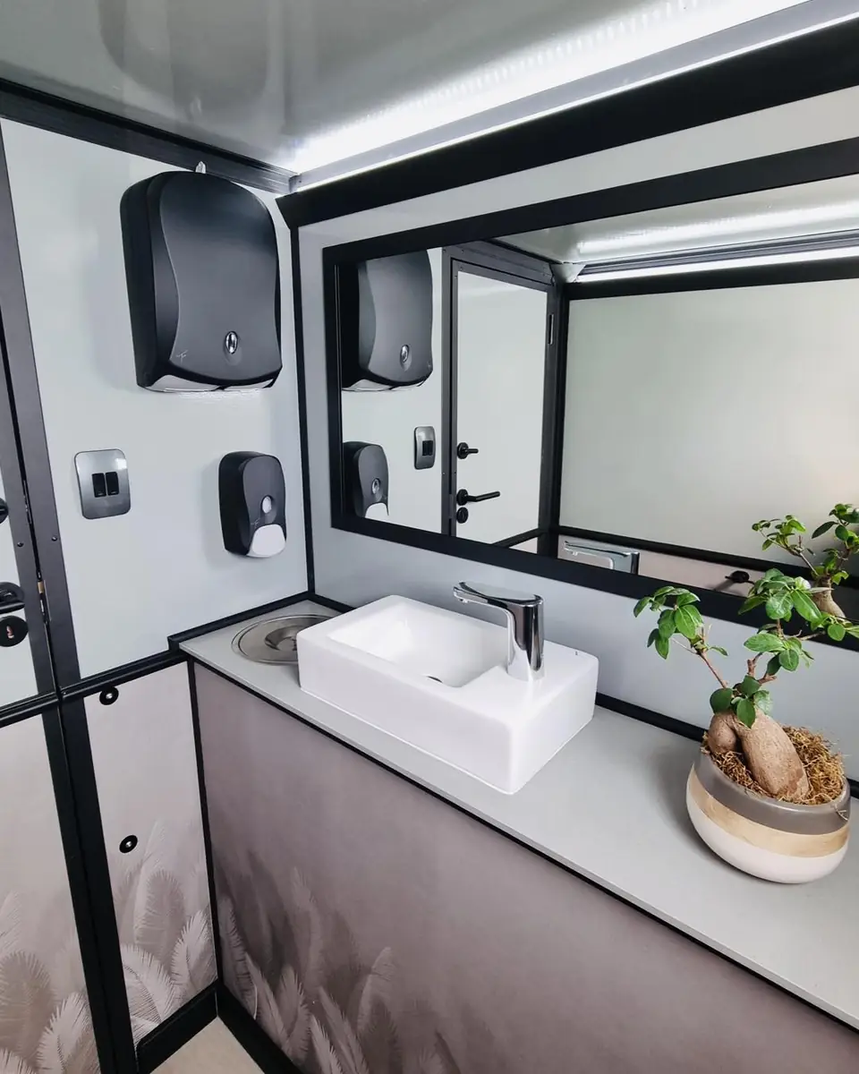 Restroom trailer vanity with a vessel sink, mirror and soap dispenser